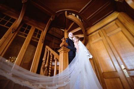 Wedding couple indoors is hugging each otherの写真素材