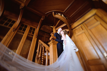 Wedding couple indoors is hugging each otherの写真素材