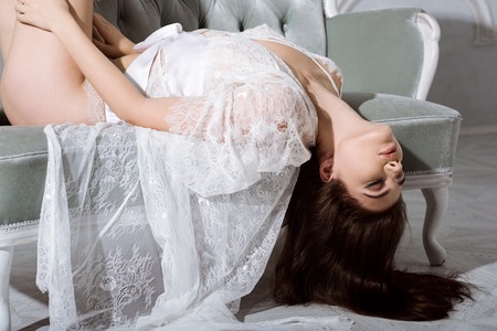 Beautiful sexy lady in elegant white robeの写真素材