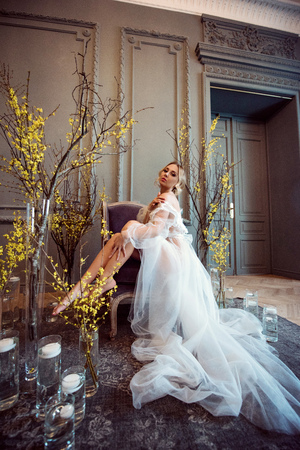 Beautiful sexy lady in elegant white robeの写真素材
