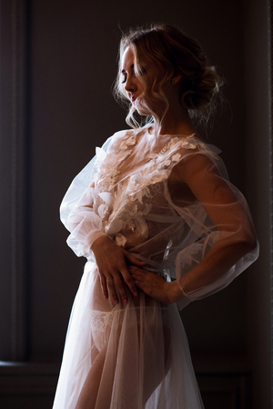 Beautiful sexy lady in elegant white robeの写真素材
