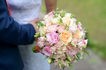 Wedding couple with bouquet. Female and male portraitの写真素材