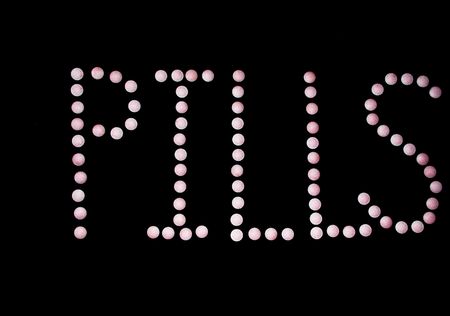 The word pills spelled out with tabletsの写真素材