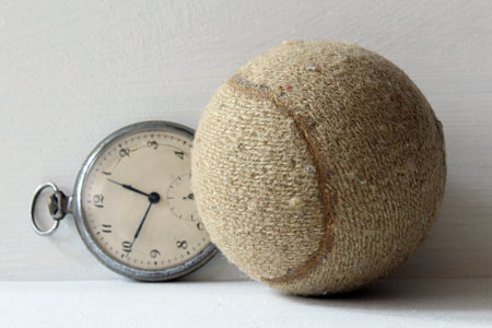 tennis ball and stopwatch on a white background