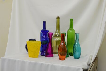 still life of colored bottles on a white backgroundの写真素材