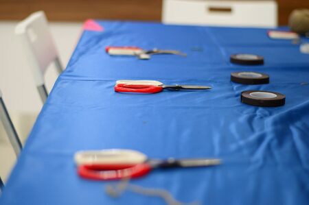 a few scissors lying on the blue florists tableの写真素材