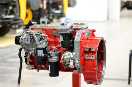 Red disassembled tractor engine stands on the stand