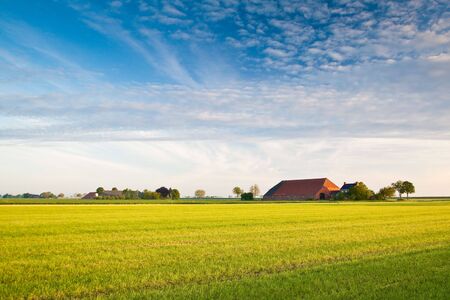 Countryside with farmer and meadowsの写真素材