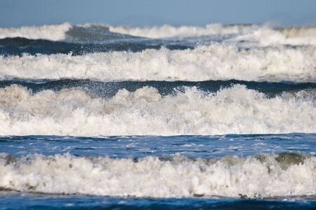 White heads on the waves in the seaの写真素材