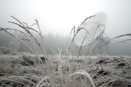 A dish telescope in the forest in winter timeの写真素材