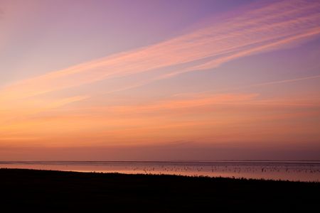 Colorful sunrise at the wadden sea coastlineの写真素材