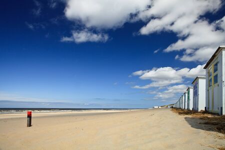 small rental cabin on the beach with clouds in the blue skyの写真素材