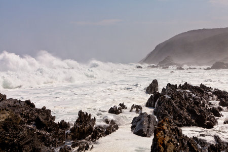 High wave breaking on the rocks of the coastlineの写真素材