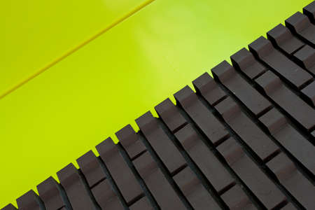 Brick wall texture with yellow panel in close upの写真素材