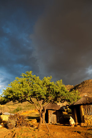 Houses  in beautiful evening light with thunderstorm clouds