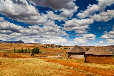 Village in a valley in africa with beautiful cloudscapeの写真素材