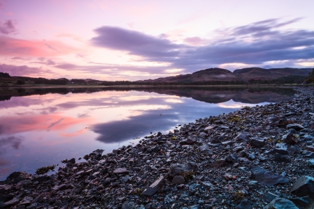 Colorful cloudy sunrise at a lake in Scotlandの写真素材