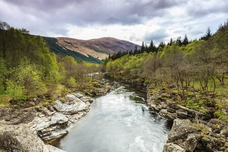 Calm river in mountain landscape in scotolandの写真素材
