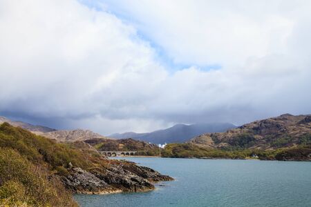 Rough lake landscape with dark clouds in the skyの写真素材