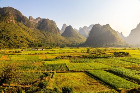 Morning sun over limestone rock formations in South Chinaの写真素材