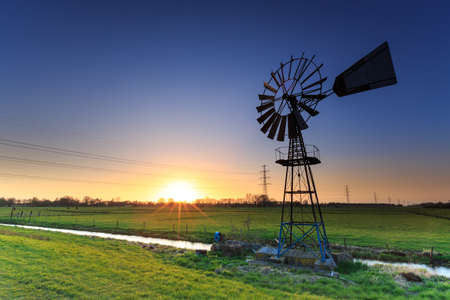 Water windmill in a typical dutch landscapeの写真素材