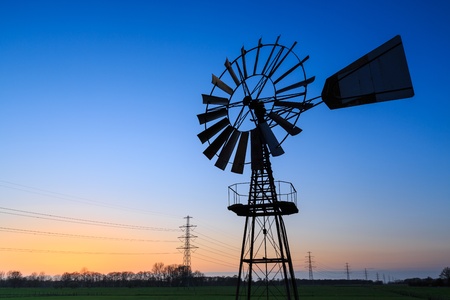 Windmill in a dutch landscape at sunsetの写真素材