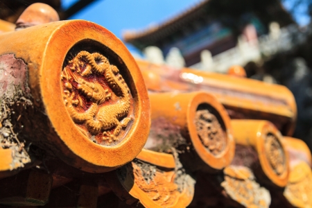 Rooftop with decorative dragon tiles in yellowの写真素材