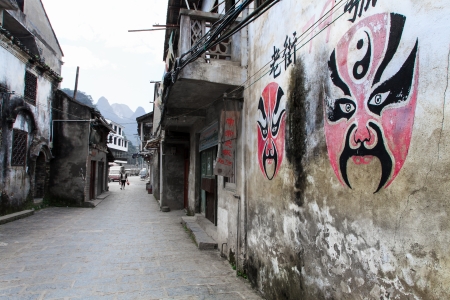 Face paintings of the Beijing opera on a wall in the streetのeditorial素材