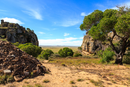 Steep rocks formations with valley in the background lit by sun in Africaの写真素材