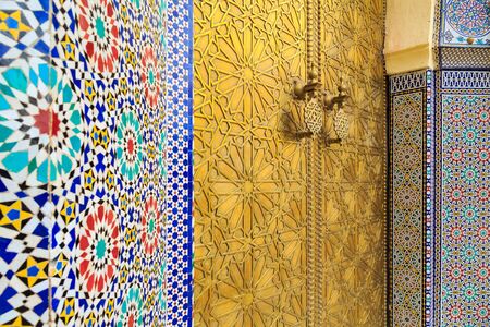 Entrance door with mosiac and brass door at the Royal palace in Fes Moroccoの写真素材