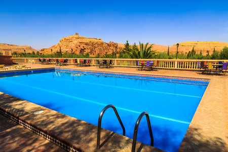 Swimming pool near the kasbah Ait Ben Haddou in the Moroccan Atlas mountainsのeditorial素材