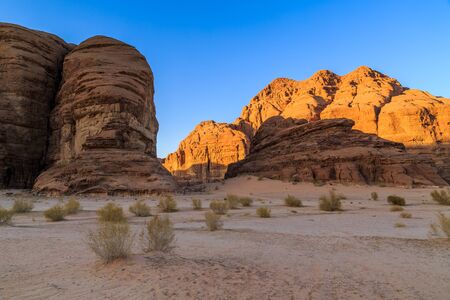 Scenic view of the yellow colored mountain rocks in the Wadi rum desert in Jordan at early-morning sunriseの写真素材