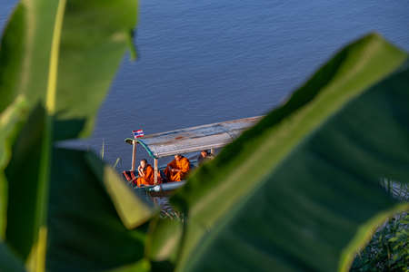 Unidentified Buddhist monk rowing boat on the river.の写真素材