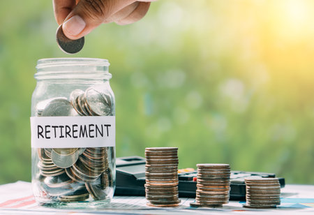 Hand putting money for retirement money for the future.Saving for retirement concept.