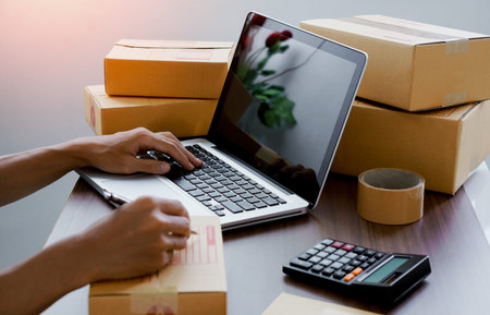 The online seller write customer address and check customer addrees for delivery to the customer.The...
