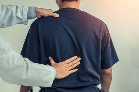 Doctor or Physiotherapist consulting with patient Back problems.Physical therapy concept.の写真素材