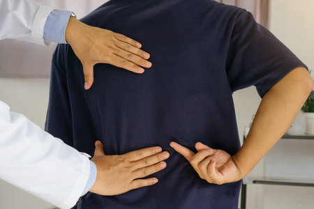 Doctor or Physiotherapist consulting with patient Back problems.Physical therapy concept.
