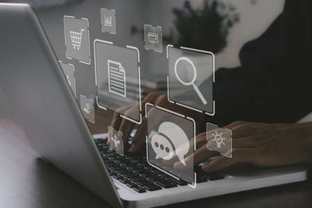 Digital Marketing Concept.Businessman hand working with laptop computer, tablet and smart phone in office with virtual icon diagram.の写真素材