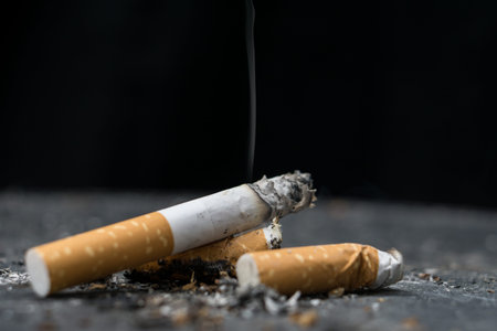 Cigarette.Closeup cigarette and cigarette butt on the floor.World No Tobacco Day Concept Stop...