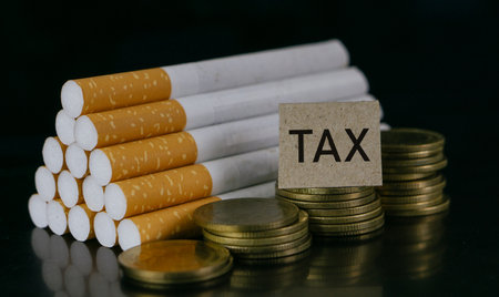 Cigarettes and TAX word on black background.Cigarettes and TAX concept. Smoking is a waste of money.Cost of smoking, Cigarette price concept.の写真素材