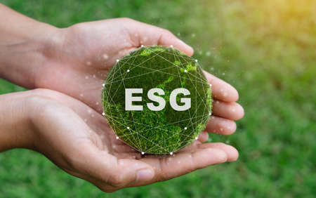 ESG icon concept in the woman hand for environmental, social, and governance by using technology of renewable resources to reduce pollution and carbon emission . in sustainable and ethical business on the Network connectionの写真素材
