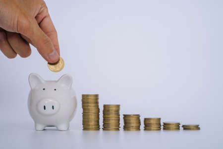 Coin stack with piggy bank on white background.Inflation concept.Saving money concept.の写真素材