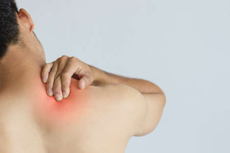 Young man suffering from neck pain.Office syndrome Concept. Headache pain.Health concept.の写真素材