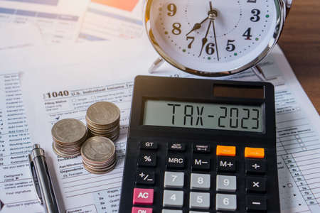 Tax word and 2023 number on calculator. Pay tax or vat in 2023 years. Business and tax concept.の写真素材
