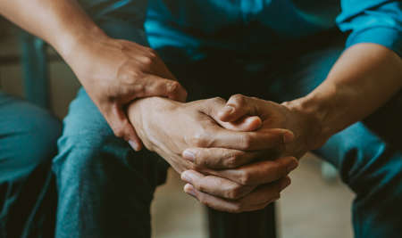 Stressed man in a consultation with a professional psychologist listens to advice on improving behavior in life.depression, stress, irritability, and life problems.の写真素材