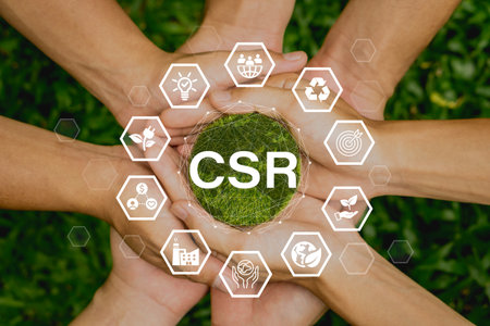 CSR(Corporate social and responsibility) icon concept in the hands for business and organization.Concept to giving back to the community on a green nature background.の写真素材