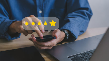 close up on customer man hand pressing on smartphone screen with gold five star rating feedback icon and press level excellent rank for giving best score point to review the service , business conceptの写真素材