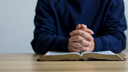 Bible concept.Man hands Praying to god with the bible. believe in goodness. Holding hands in prayer...