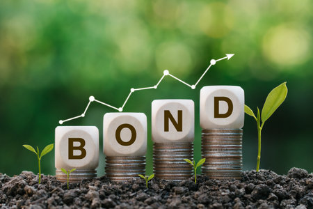 Investment on bonds concept.Green Bonds word in wooden block on stack coin with green background. Raising funds to fund environmentally friendly projects.ESG, Carbon.Net zero emission.の写真素材