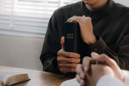 Christian man hands holding the holy bible to pray and worship God in the sunday morning.spirituality, religion,believe.Christian life.Studying the word of God in church.の写真素材